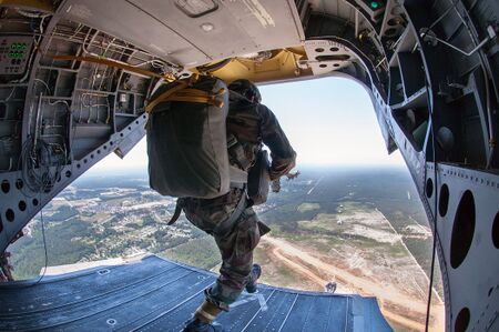 An Indian Army paratrooper with the 50th Parachute Brigade jumps from a helicopter